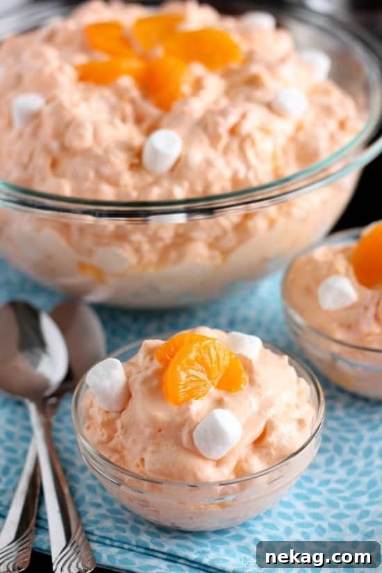 A vibrant Orange Fluff Fruit Salad, quickly assembled with minimal ingredients, perfect for potlucks.