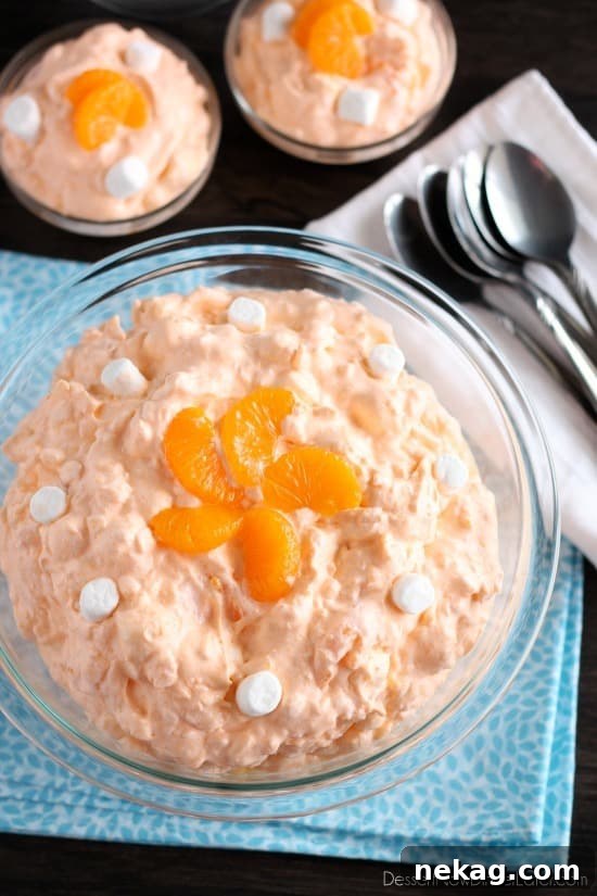 Preparing the Orange Fluff Fruit Salad, showcasing the ease of combining ingredients.