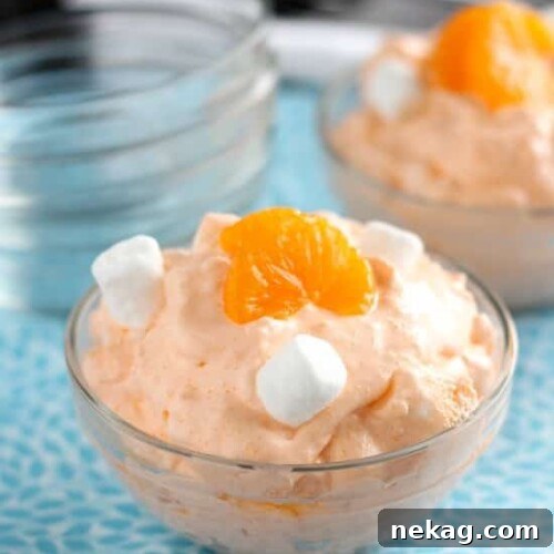 A beautifully presented Orange Fluff Fruit Salad, highlighting its creamy texture and fresh fruit.