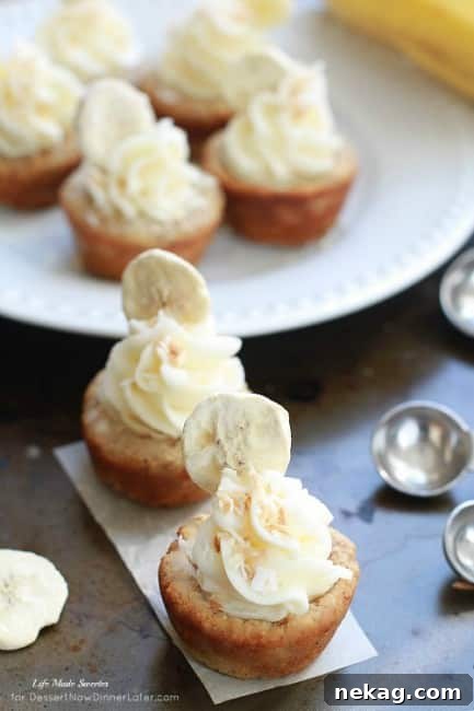 Island-Inspired Banana Coconut Cookie Bites 5 A plate of several Banana Coconut Mini Cookie Cups, garnished with toasted coconut flakes and fresh banana slices, ready for a tropical celebration.