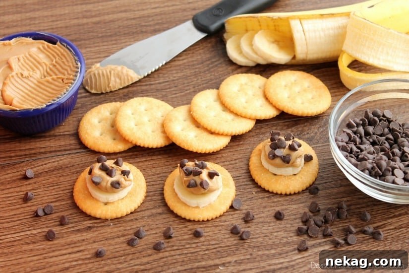Final step: sprinkling chocolate chips over the peanut butter and banana on the RITZ® cracker for a finished snack.