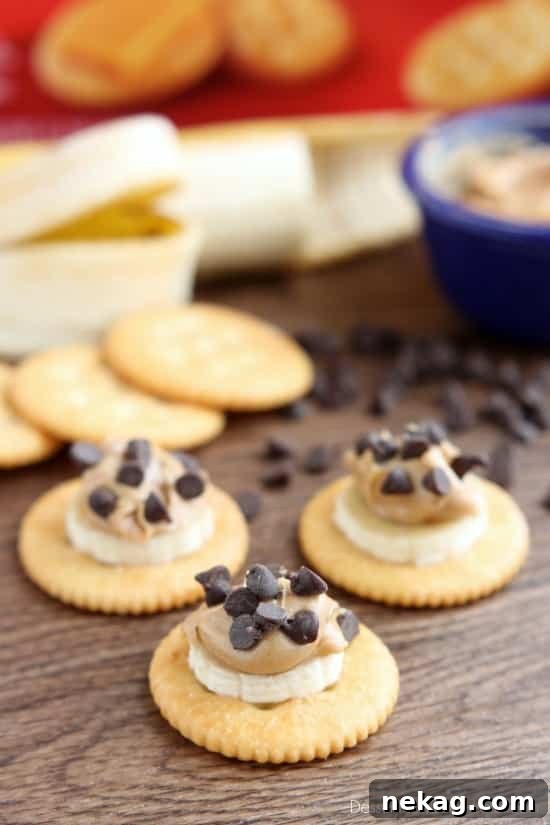 A young girl happily enjoying the Chocolate Peanut Butter Banana RITZ® Bites she just made.