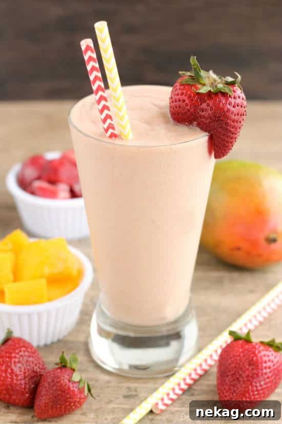 Creamy Dairy-Free Strawberry Mango Delight 2 Vibrant Strawberry Mango Dairy-Free Smoothie in a glass, ready for breakfast or a healthy snack.