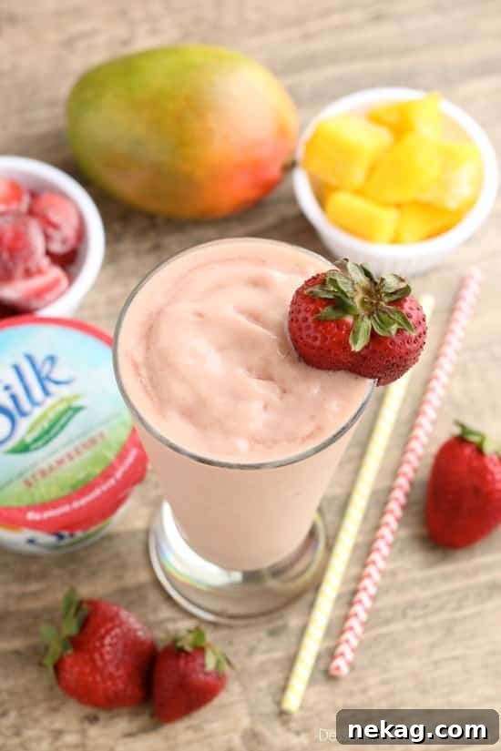 Creamy Dairy-Free Strawberry Mango Delight 4 Close-up of a refreshing Strawberry Mango Dairy-Free Smoothie, garnished with fresh strawberries, ideal for a light meal.