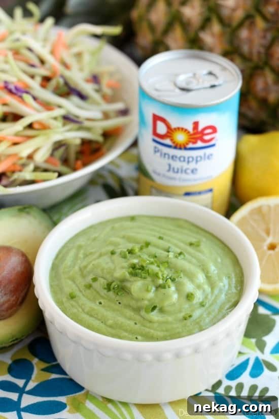 Vibrant Pineapple Avocado Dressing 2 Freshly blended Pineapple Avocado Dressing, vibrant green and creamy, ready to be served on a summer day.