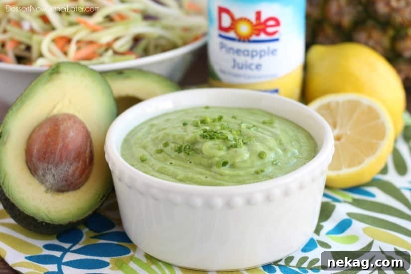 Vibrant Pineapple Avocado Dressing 3 Pineapple Avocado Dressing generously drizzled over a crisp bowl of fresh broccoli slaw, ready for a healthy meal.