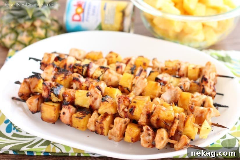 Vibrant Pineapple Avocado Dressing 6 Plated Island Chicken Skewers with fresh DOLE Pineapple Chunks, beautifully glazed and garnished, ready to enjoy.