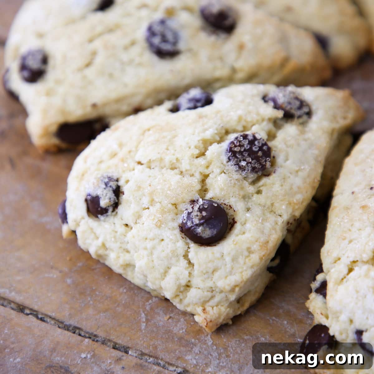 Classic Chocolate Chip Scones 4 Delicious chocolate chip breakfast pastry arranged on a rustic wooden board, ready to be served.