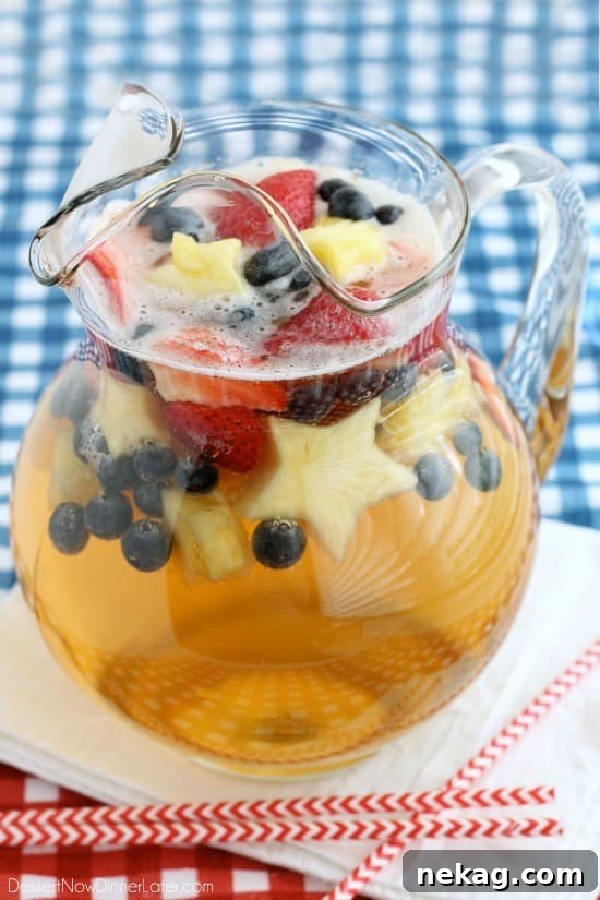 Patriotic Spark 7 Mixing the Patriotic Punch: a large pitcher with white grape juice and ginger ale being combined, ready for fruit
