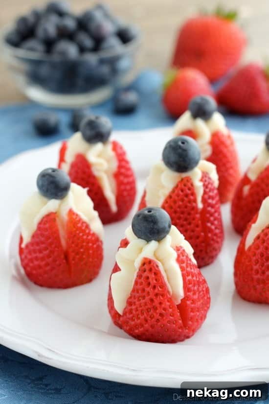 Strawberry Cheesecake Delights 2 Red, White, and Blue Cheesecake Stuffed Strawberries arranged for a festive patriotic dessert.