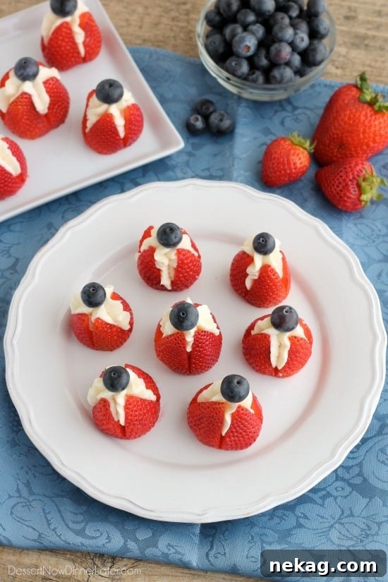 Strawberry Cheesecake Delights 6 Finished red, white, and blue cheesecake stuffed strawberries, ready to serve.