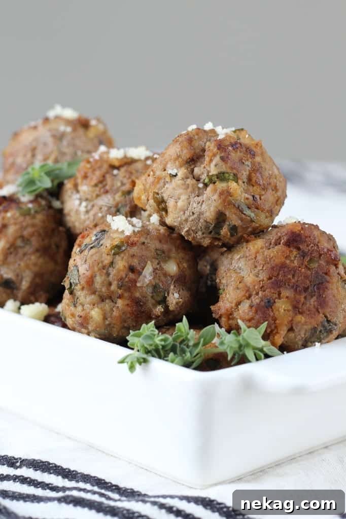 Nonna's Italian Meatballs 6 A platter of perfectly browned Italian Meatballs, garnished with fresh basil leaves