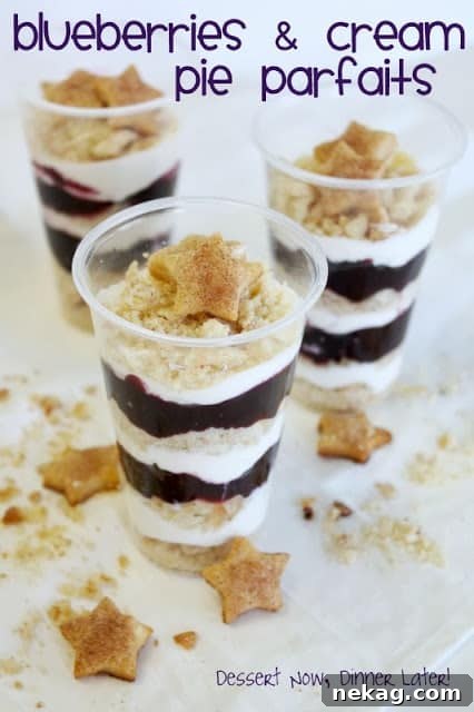 Deconstructed Blueberry Pie Parfaits 2 A refreshing parfait in a clear glass, showing distinct layers of golden-brown pie crust crumbs, white cream cheese filling, and purple blueberry compote. A star-shaped pie crust sits on top, resembling a starfish.