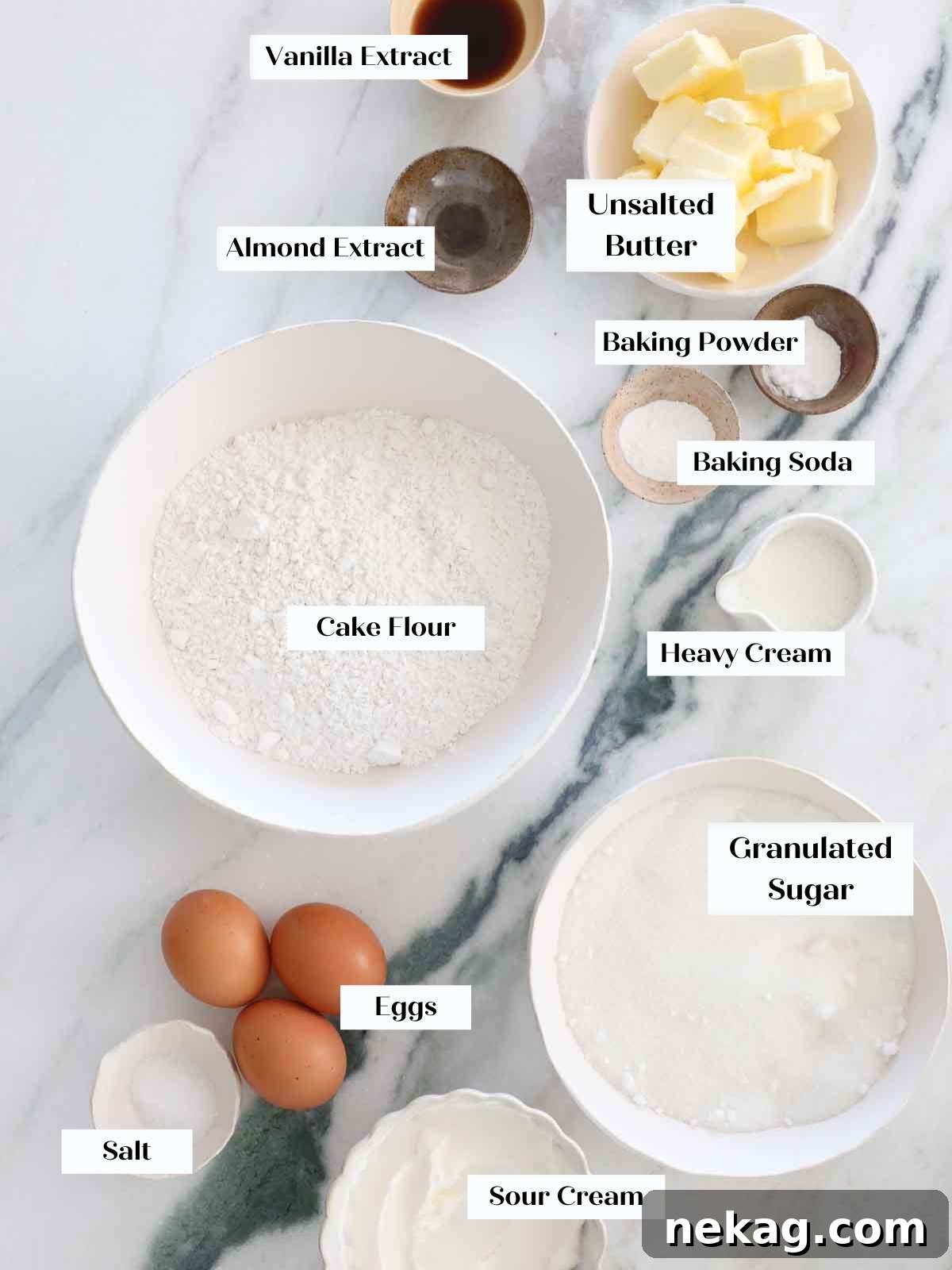 moist vanilla cake ingredients perfectly laid out on a marble surface for making an American Flag Cake.