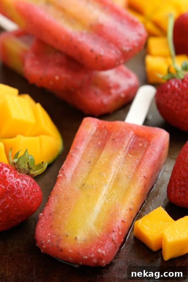 Close-up of a single Strawberry Mango Chia Popsicle, showcasing its vibrant layers and the subtle texture of chia seeds, on a white background.