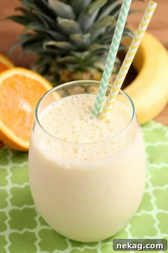 Morning Glow Blend 5 A freshly blended and frothy Sunrise Smoothie elegantly poured into a glass, ready to be savored as a refreshing and healthy beverage