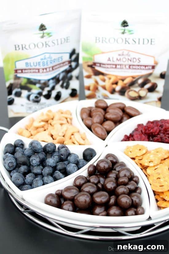 S'mores Reimagined 9 A beautifully arranged fruit and nut snack tray featuring Brookside Dark Chocolate Blueberries and Milk Chocolate Almonds, alongside fresh fruit and pretzels.