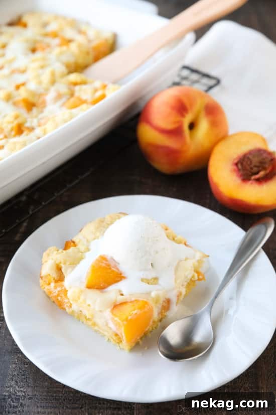 A unique dessert, Peaches and Cream Cobbler combines classic peach cobbler with a creamy cheesecake filling, featuring a cake mixture on the bottom and top.