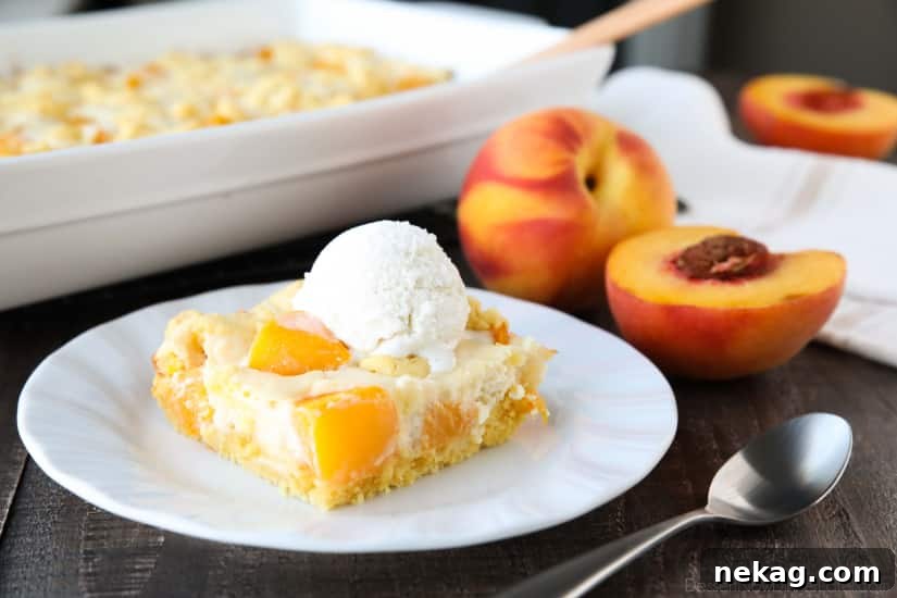 A close-up of a traditional peach cobbler, showcasing the fruit filling and a classic, rustic topping before the unique cheesecake addition.