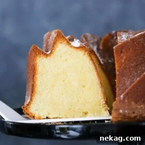 A perfect slice of Sour Cream Pound Cake on a cake server, ready to be enjoyed.