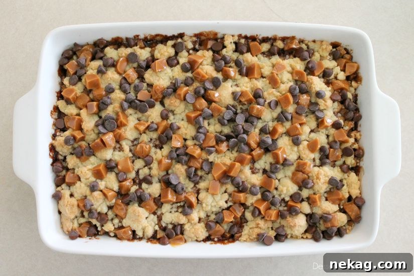 Decadent Chocolate Caramel Apple Crumble Squares 14 Baked apple crumb bars with melted caramel and chocolate on top.