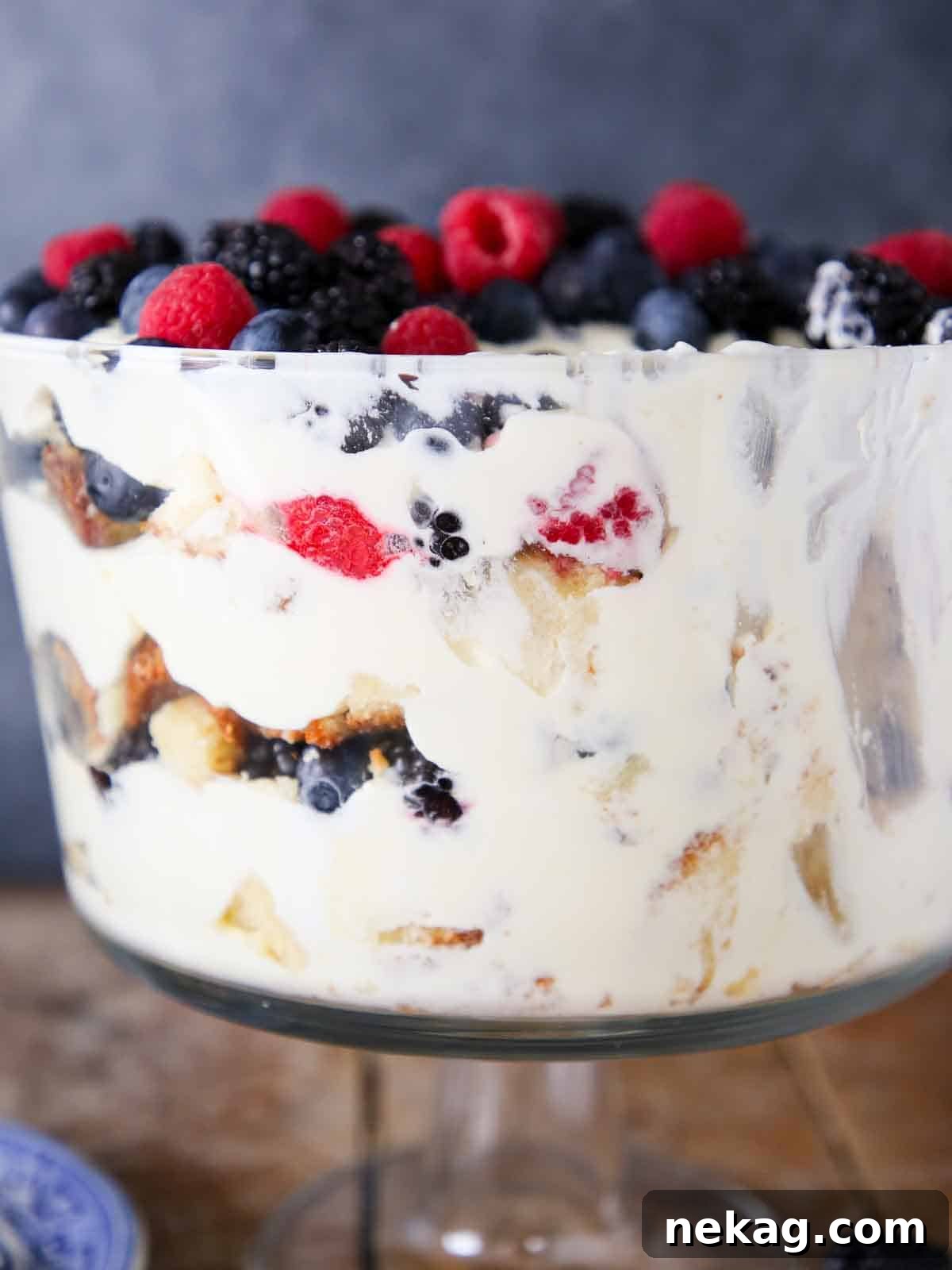 Scooped out berry trifle dish viewed from the side, showing clear layers.