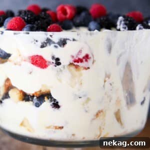 Side view of a vibrant berry trifle with lemon whipped cream, showcasing perfect layers.