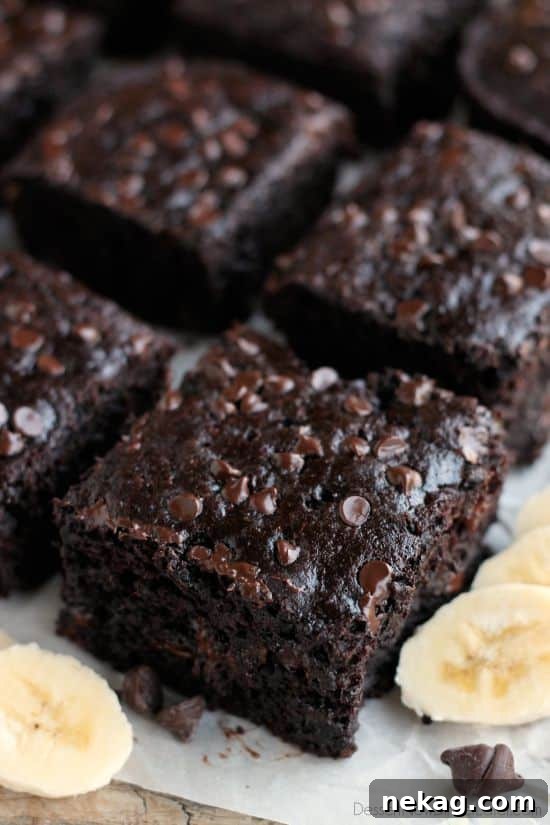 A slice of moist Double Chocolate Banana Cake with melty chocolate chips, ready to be enjoyed.