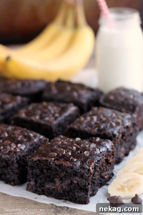 A square slice of Double Chocolate Banana Cake resting on a wire rack, showcasing its tempting appearance.