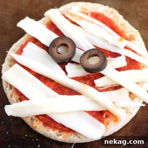Mini Mummy Pizzas, a fun and easy Halloween recipe for kids.