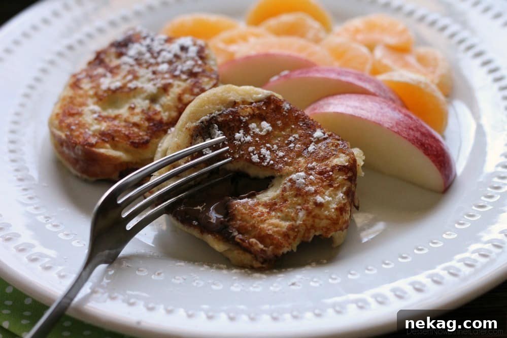 Chocolate Stuffed French Toast with a fork taking a bite, revealing the melted chocolate hazelnut spread inside.