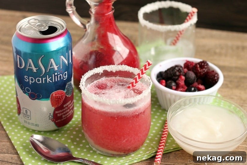 A beautifully set table featuring glasses of Berry Coconut Spritzer, ready for a festive holiday gathering.