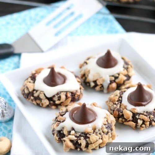 Creamy Chocolate Thumbprint Delights 6 Chocolate Cream Thumbprint Cookies with buttercream and Hershey's Kiss.