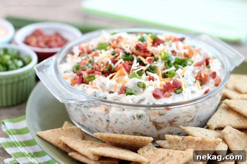 A loaded baked potato inspired this chip dip full of bacon, cheese, green onions, and ranch dressing mix. A delicious party dip or game day appetizer.