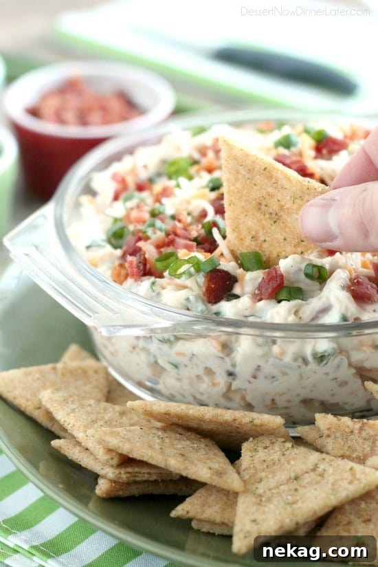 A loaded baked potato inspired this chip dip full of bacon, cheese, green onions, and ranch dressing mix. A delicious party dip or game day appetizer.