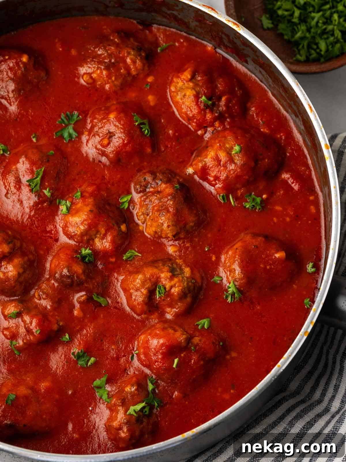Cloud-Like Ricotta Meatballs 2 Tender ricotta meatballs simmering in a rich marinara sauce, garnished with fresh parsley.