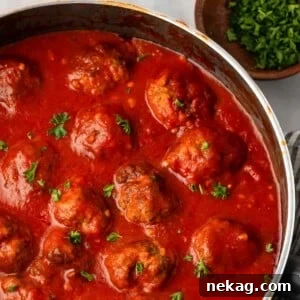 Cloud-Like Ricotta Meatballs 12 Ricotta meatballs generously coated in rich marinara sauce, ready to serve.