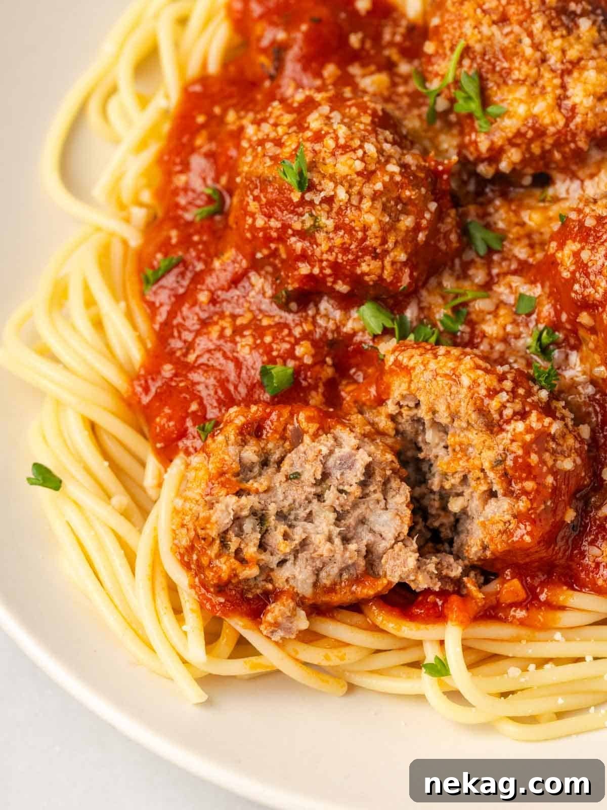 Cloud-Like Ricotta Meatballs 4 Close-up of the tender, cooked interior texture of a ricotta meatball, showing its moist and airy consistency.
