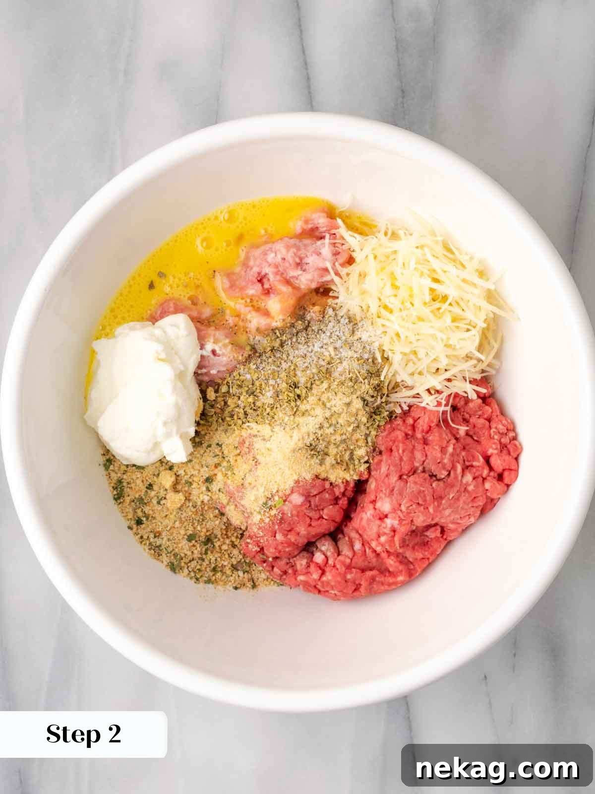 Cloud-Like Ricotta Meatballs 6 A bowl filled with raw ground meat, ricotta, egg, and spices, ready for mixing to form meatballs.