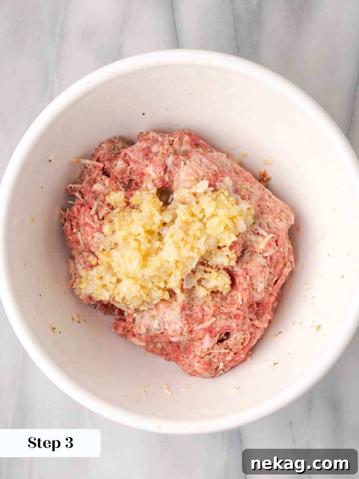 Cloud-Like Ricotta Meatballs 7 Sautéed garlic and onion resting on top of the meatball mixture in a bowl, before final combination.