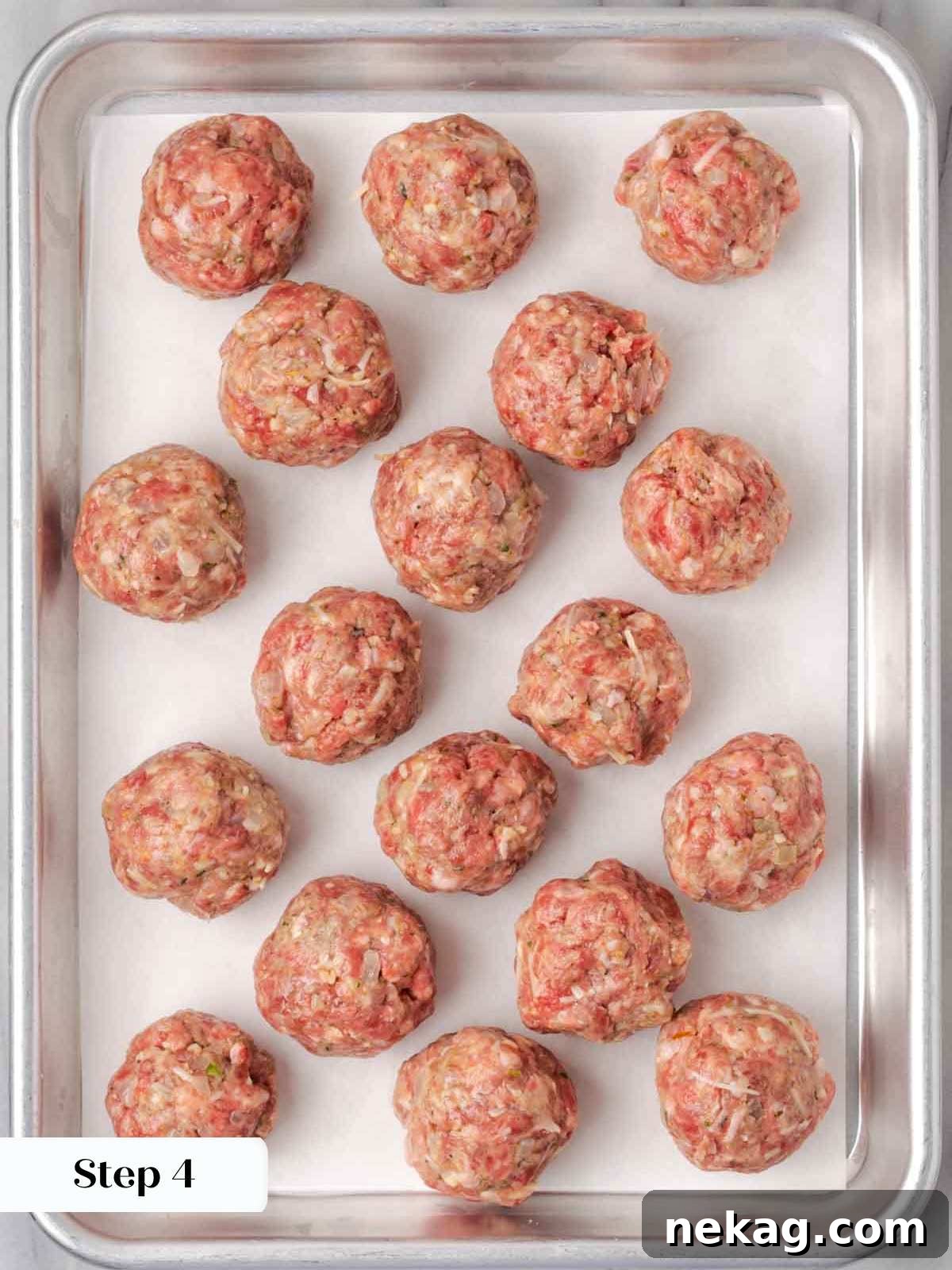 Cloud-Like Ricotta Meatballs 8 Raw, perfectly rolled, golf ball-sized meatballs arranged on a baking sheet, ready for cooking.