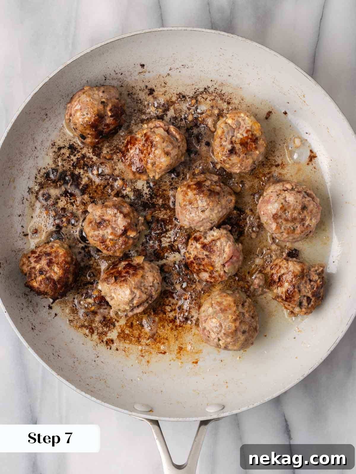 Cloud-Like Ricotta Meatballs 9 Golden-brown ricotta meatballs searing in a hot non-stick pan, developing a delicious crust.