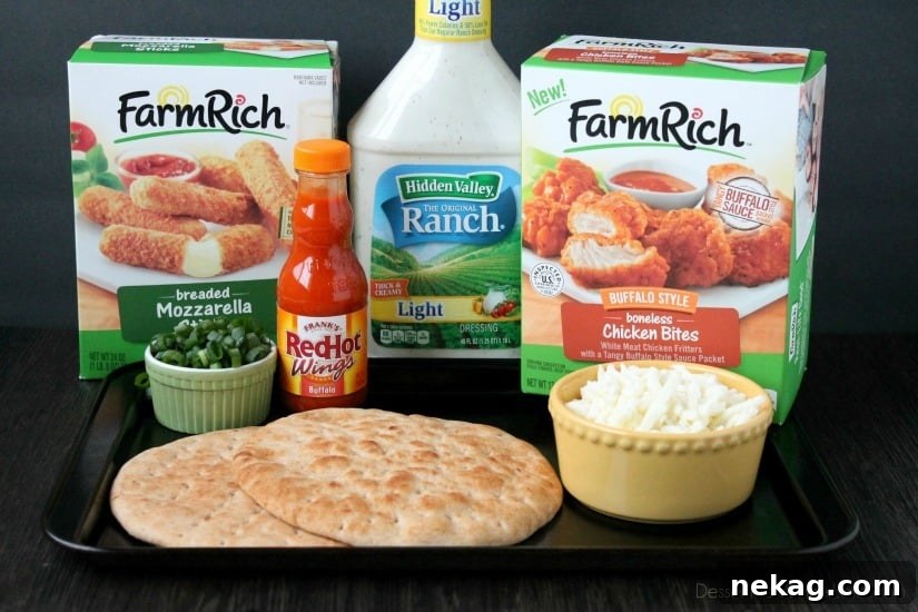 All the ingredients laid out for making Buffalo Chicken Flatbread Pizza: Farm Rich Boneless Buffalo Chicken Bites, flatbread, buffalo sauce, mozzarella cheese, and green onions.
