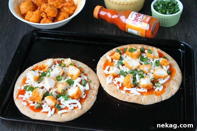 Buffalo Chicken Flatbread Pizza baking in the oven until the cheese is melted and bubbly.
