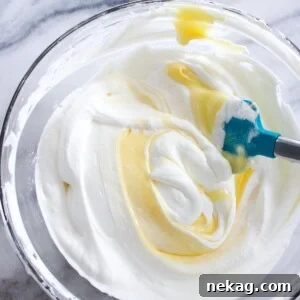 Lemon Curd Whipped Cream being gently folded