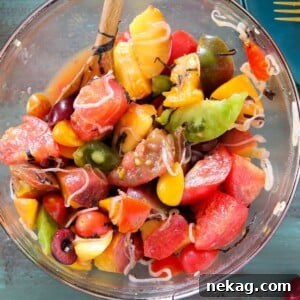 Marinated Tomato Stone Fruit Salad in mixing bowl