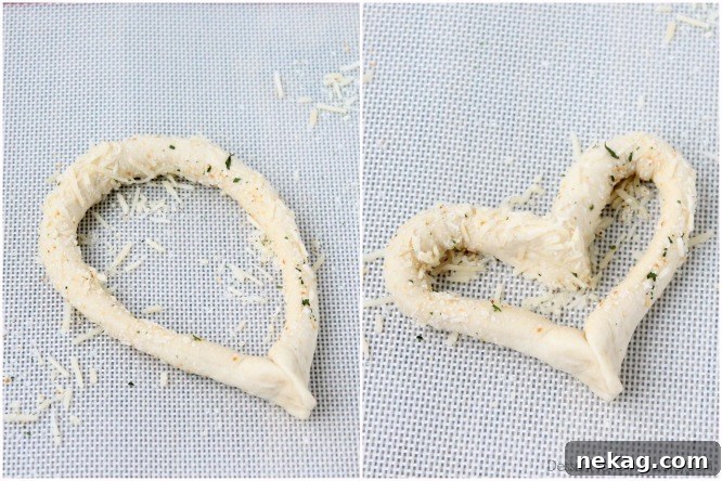 Detailed steps on how to make heart shaped breadsticks: Pinch ends of breadstick together, then press the rounded top down into a point like the bottom of the heart.