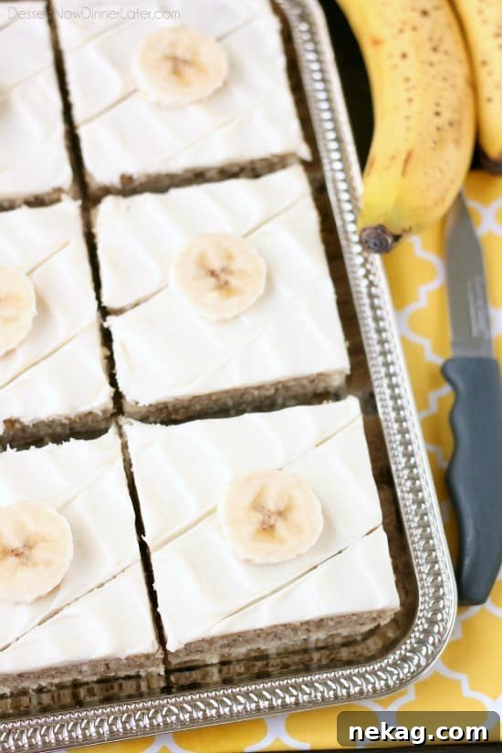 The finished banana sheet cake, generously covered in creamy, swirled cream cheese frosting, ready for a special occasion.