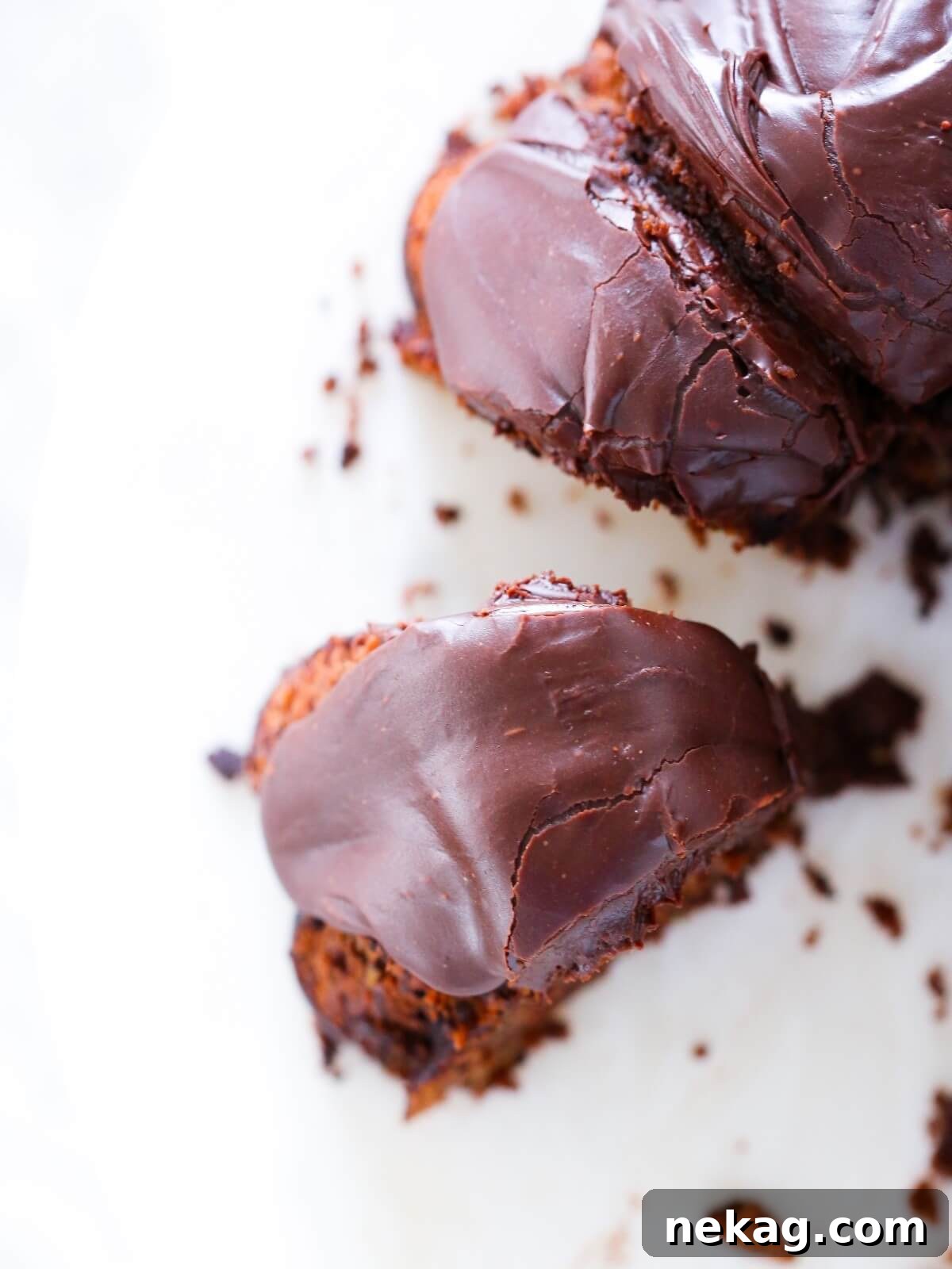 A beautifully sliced chocolate zucchini cake on a white plate, ready to be enjoyed.