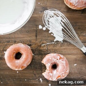 Classic Donut Glaze coating a stack of yeasted donuts on a wood board, representing the delicious finished recipe.